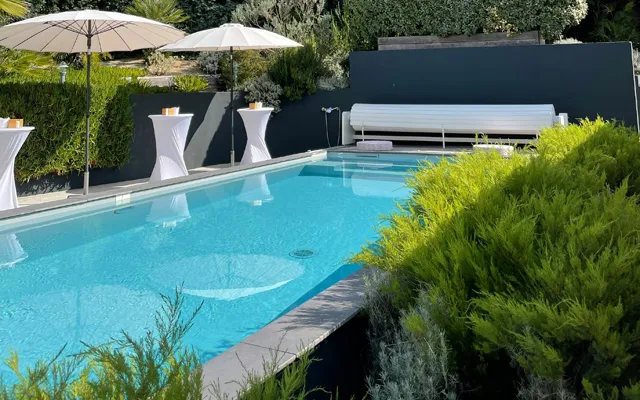 Backyard swimming pool with umbrellas