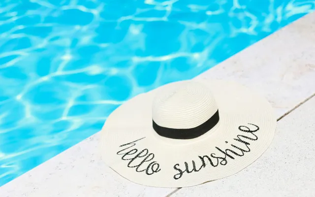 Sun hat next to swimming pool